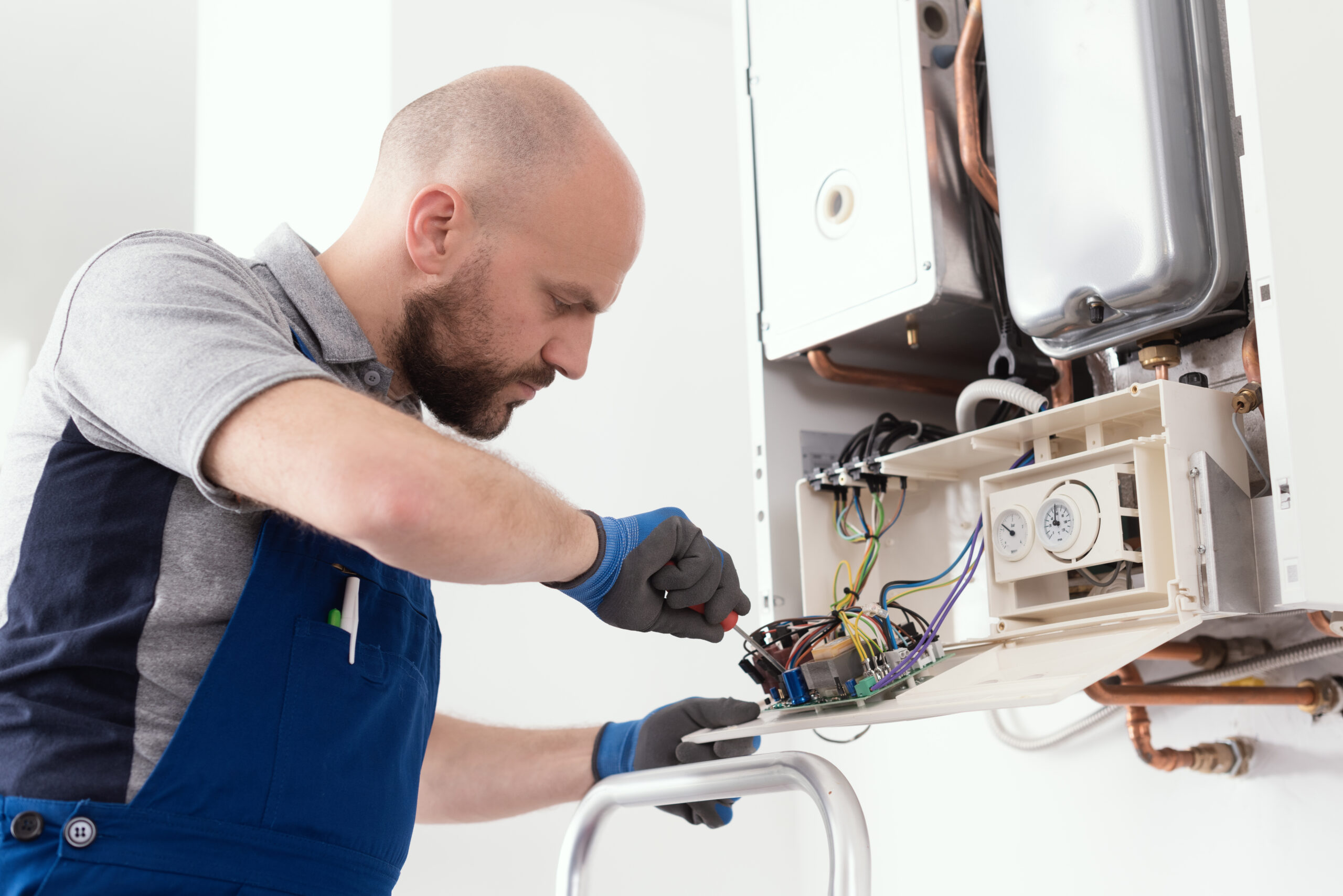 HVAC technician maintaining a residential heating system