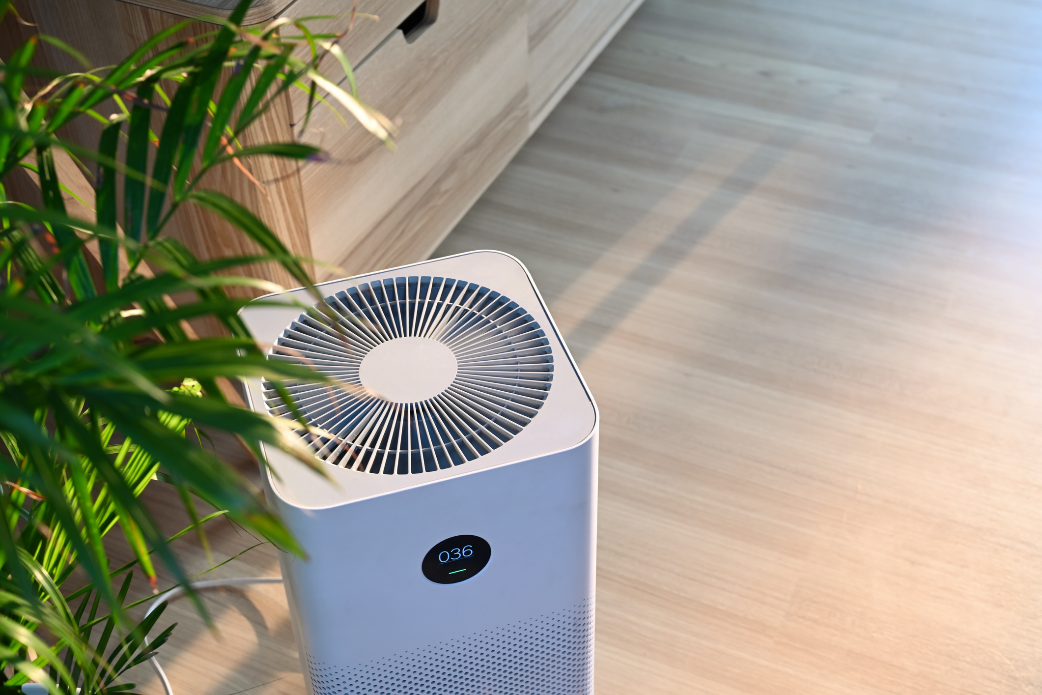 Air purifier on wooden floor in comfortable home producing fresh air