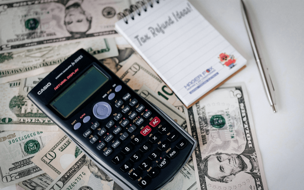 Maximize Your Tax Refund - Hager Fox Blog. Image contains calculator, money, note pad, Hager Fox logo, and Hager Fox Mascott