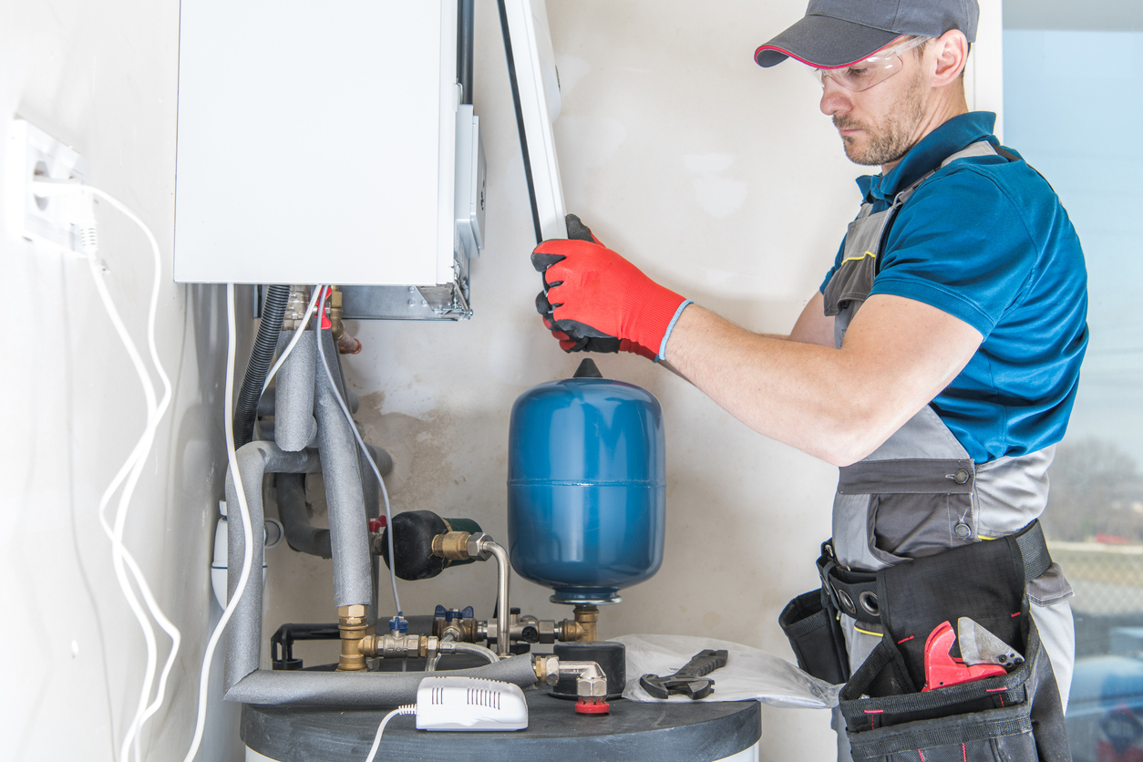 HVAC technician installing a gas heating system in a Michigan home