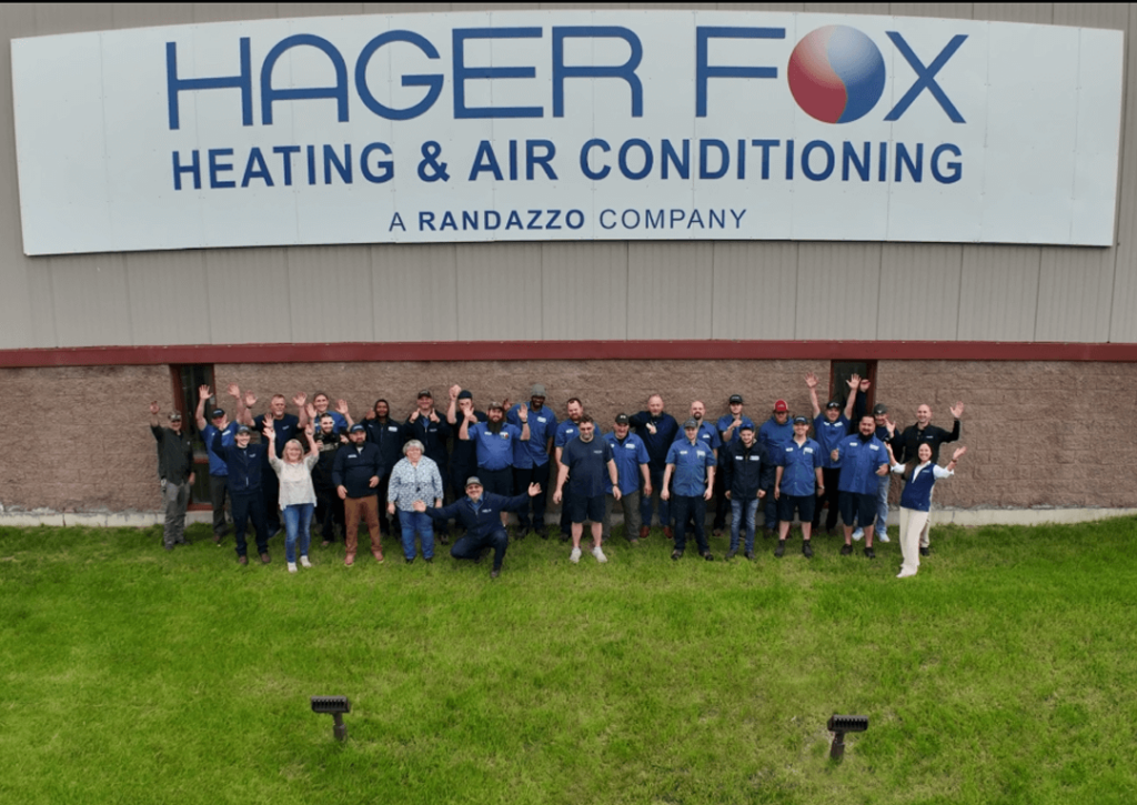 Team Standing in front of the Hager Fox building cheering