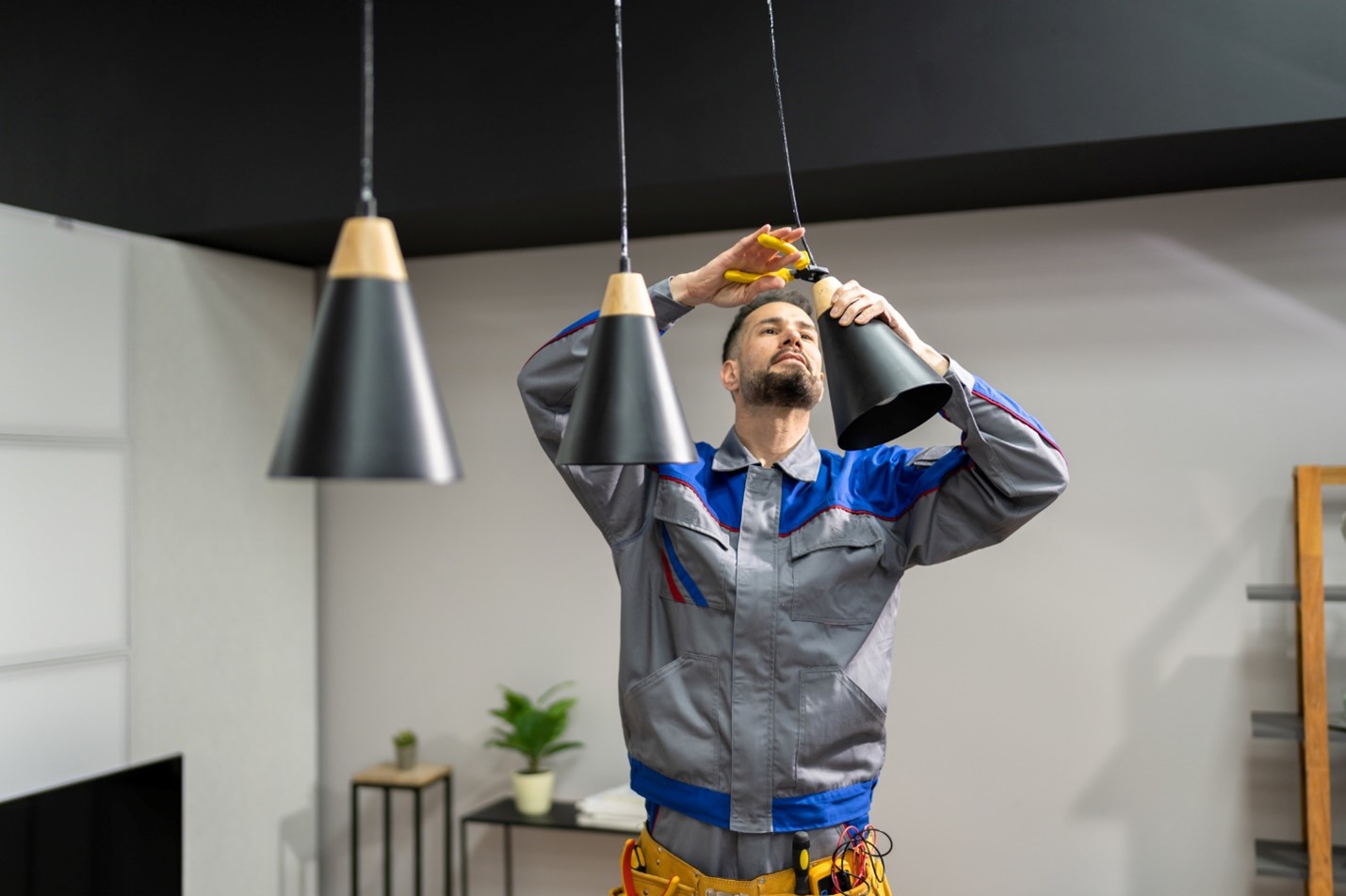 Electrician installing new lighting in a Michigan home