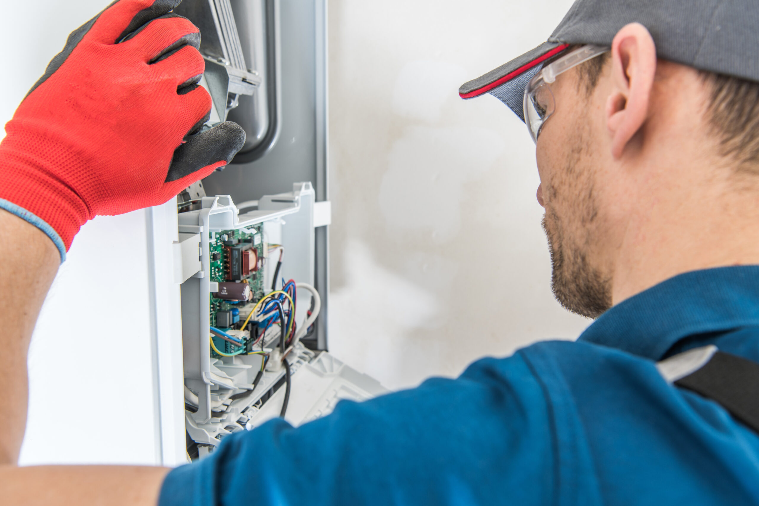 Technician performing a repair service on a gas furnace