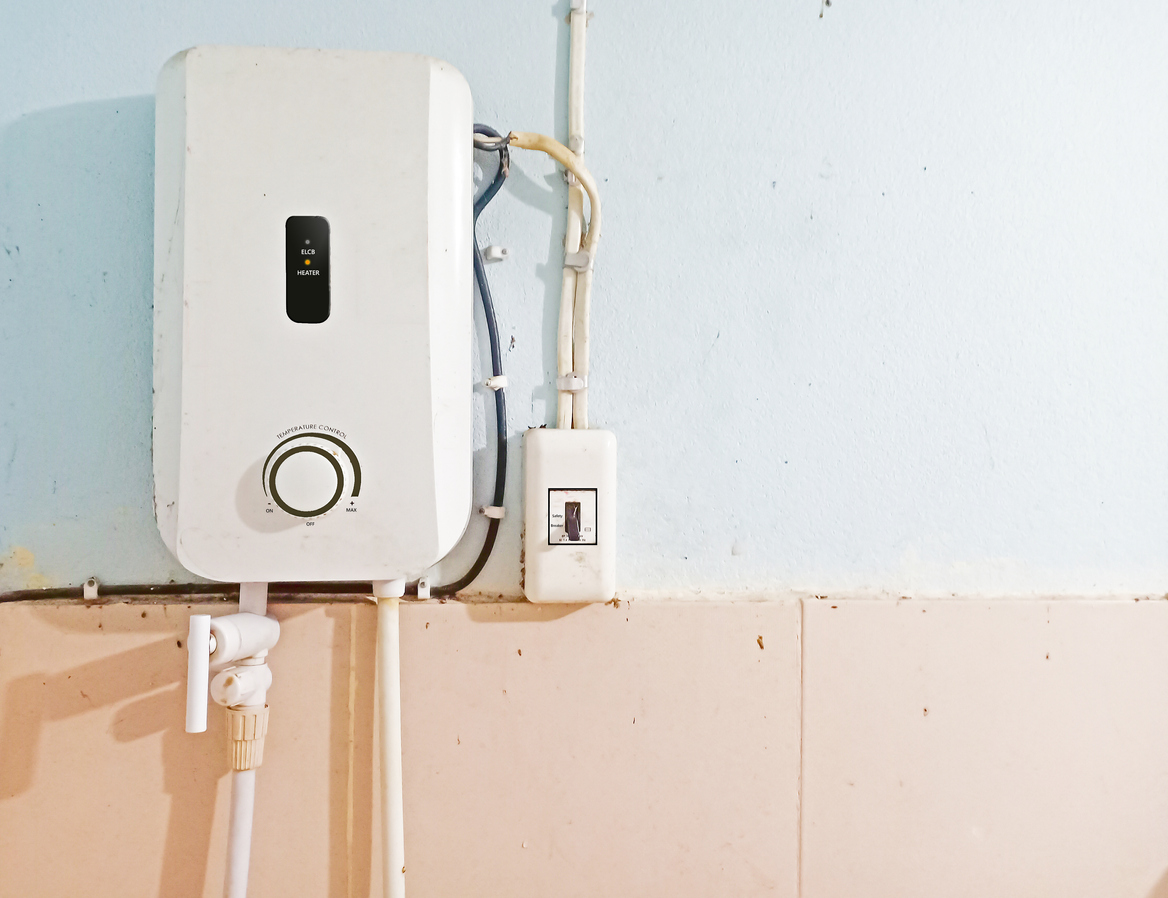 White tankless water heater installed on the wall of bathroom water heater