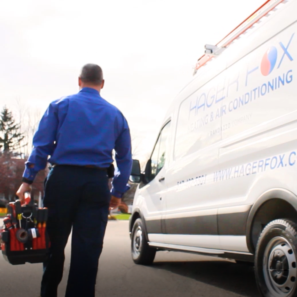 Tech walking to service a customer's furnace
