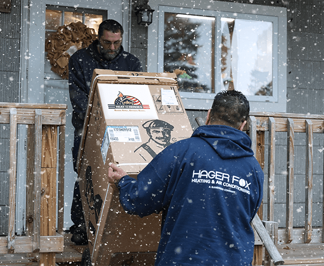 Two Hager Fox technicians installing a new furnace.
